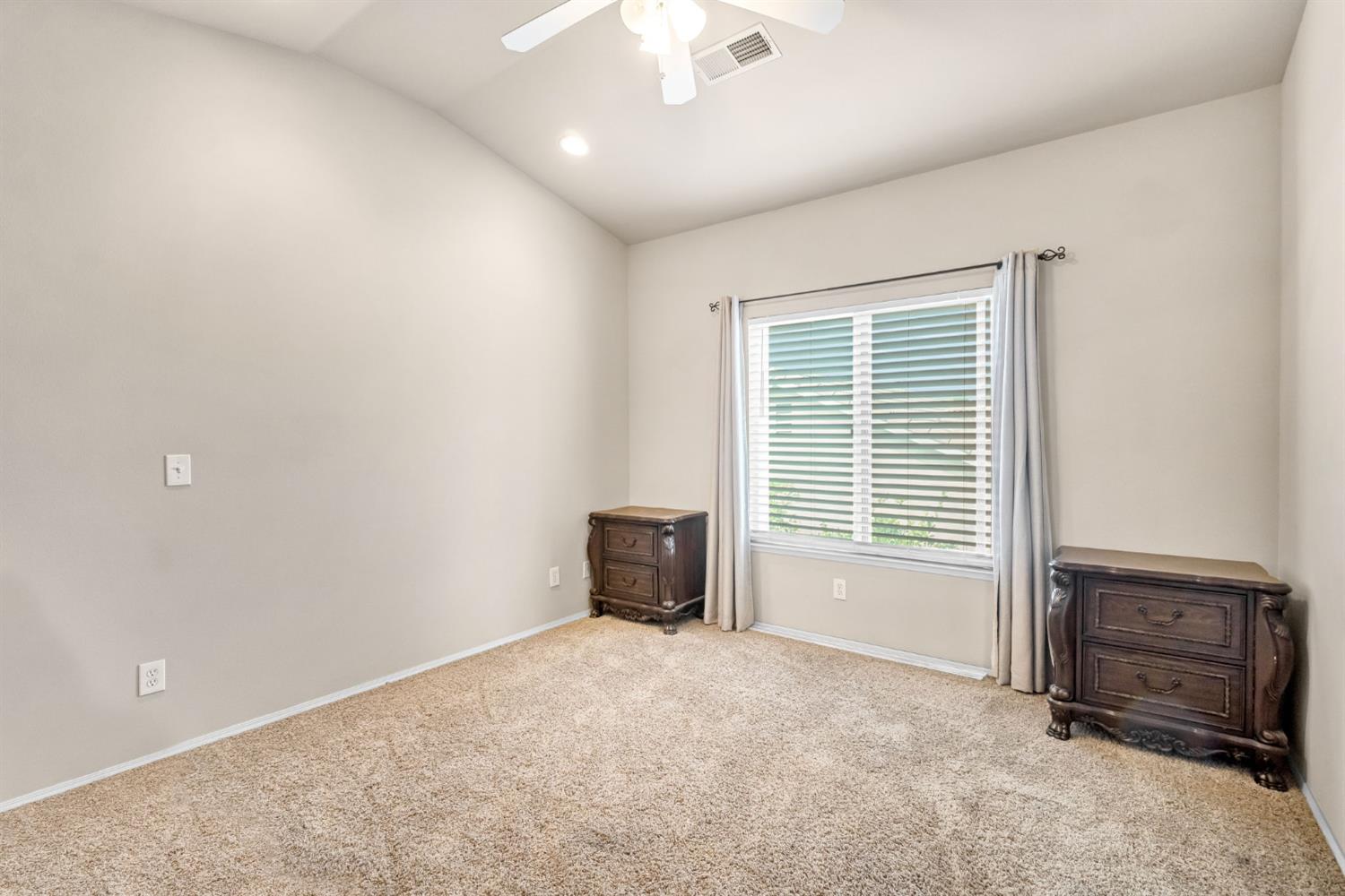 12 Breeze Way Madera, CA 93637 - Photo 32 of 56 an empty room with furniture and a window