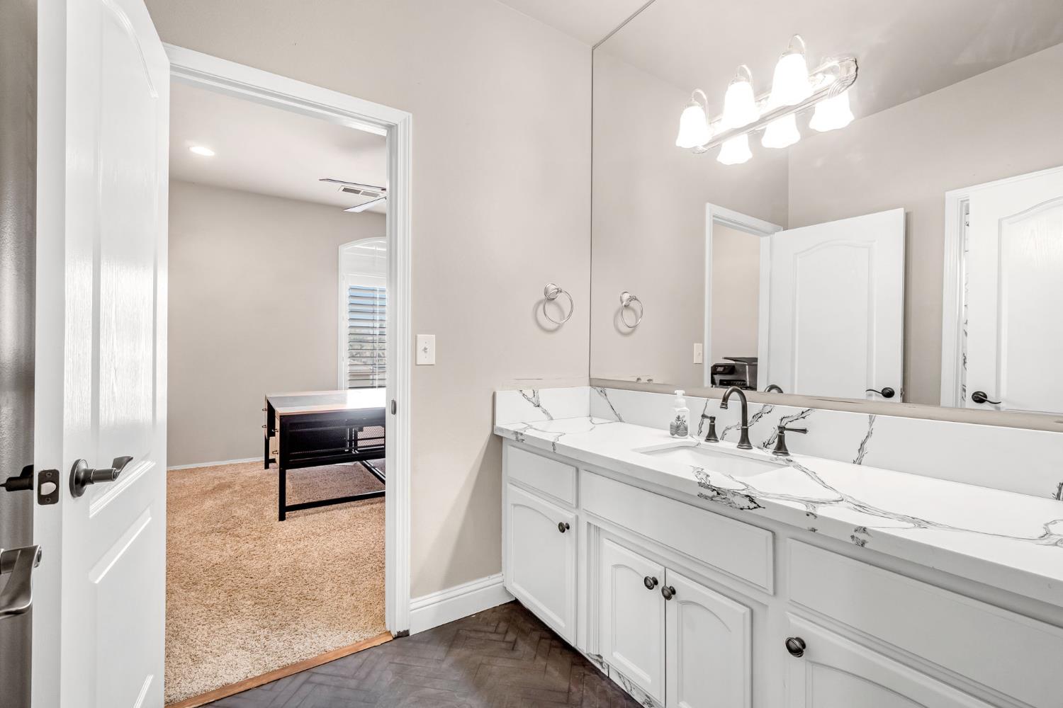 12 Breeze Way Madera, CA 93637 - Photo 34 of 56 a bathroom with double vanity sink a vanity and a mirror