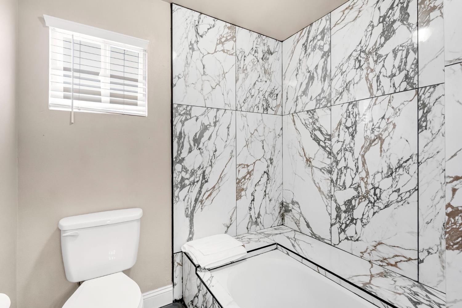 12 Breeze Way Madera, CA 93637 - Photo 35 of 56 a bathroom with a toilet and a shower curtain