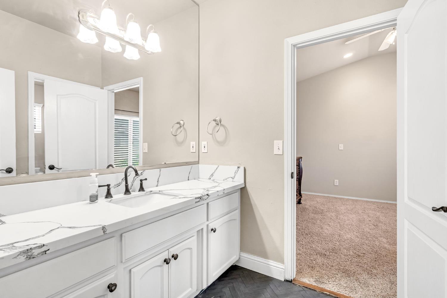 12 Breeze Way Madera, CA 93637 - Photo 36 of 56 a bathroom with a double vanity sink and a mirror