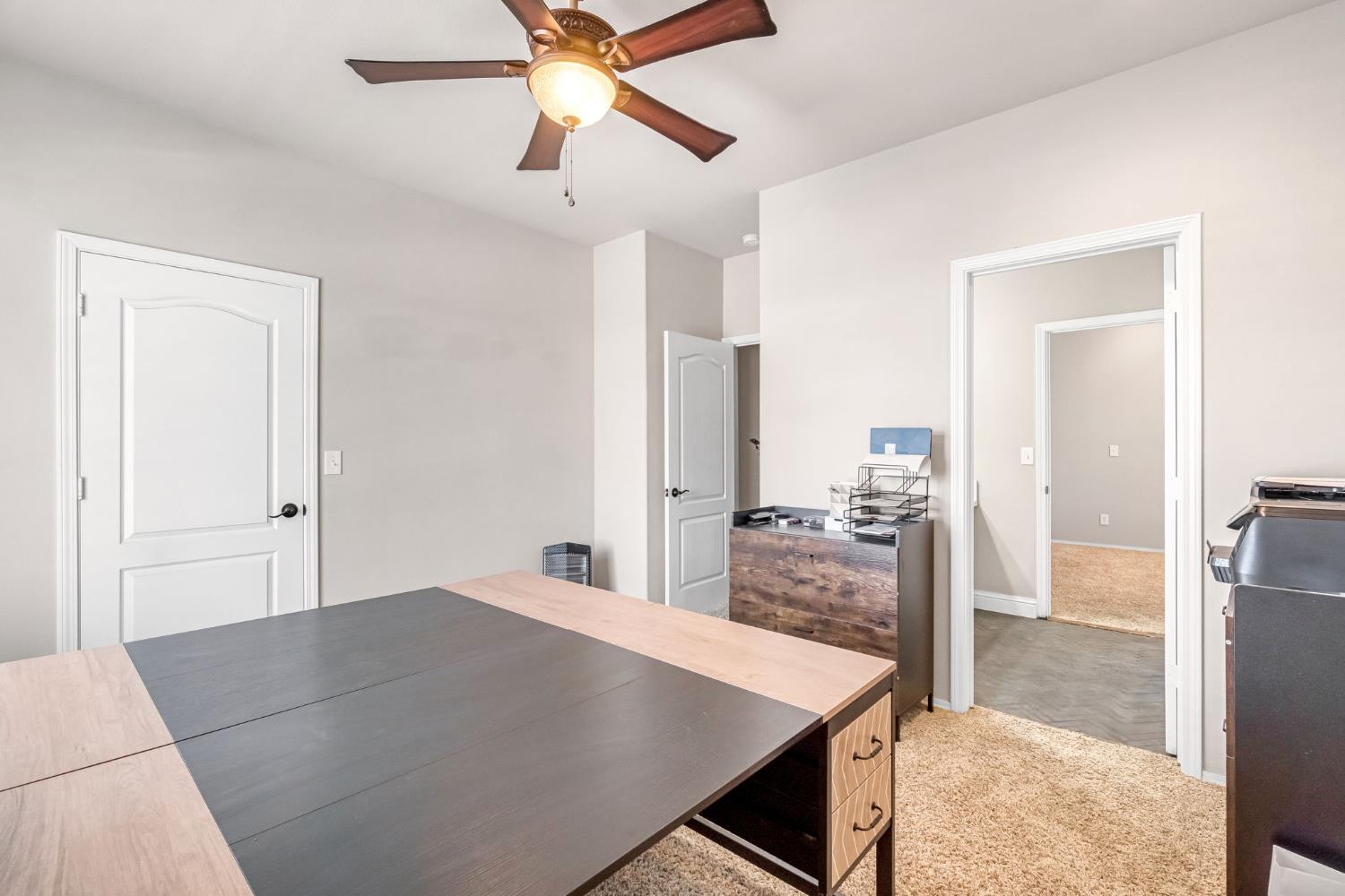 12 Breeze Way Madera, CA 93637 - Photo 38 of 56 a large bedroom with a bed and a chandelier