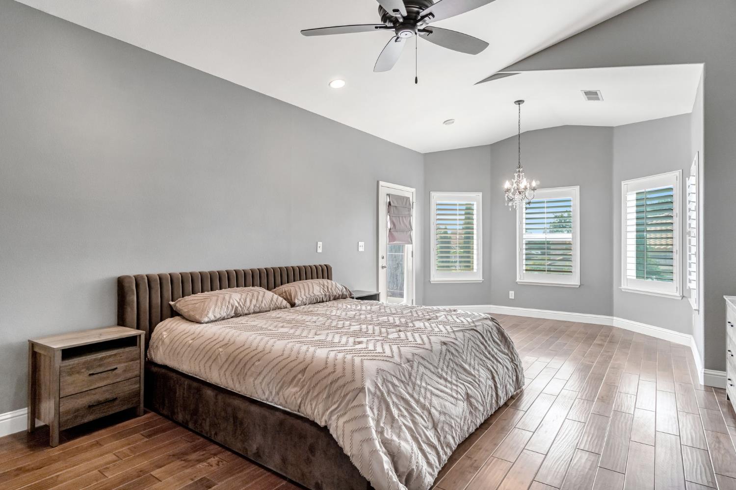 12 Breeze Way Madera, CA 93637 - Photo 40 of 56 a bedroom with a large bed and wooden floor