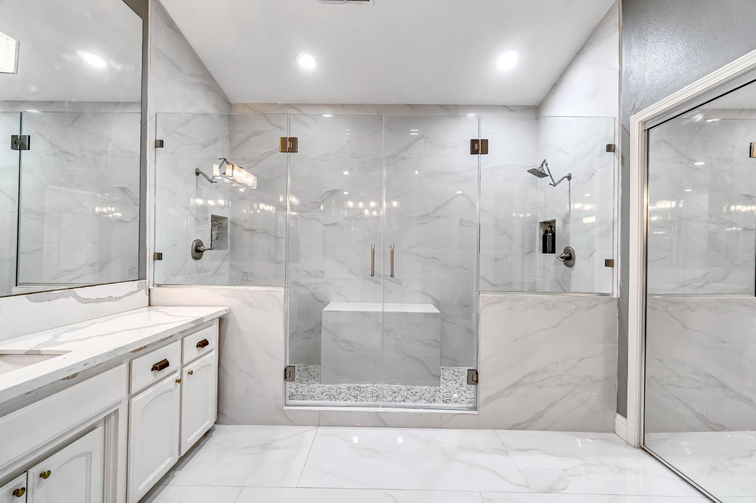 12 Breeze Way Madera, CA 93637 - Photo 43 of 56 a bathroom with a double vanity sink mirror and shower