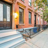 a view of a brick house with large windows
