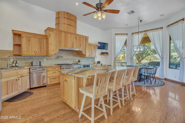 a dining room with furniture a chandelier and wooden floor