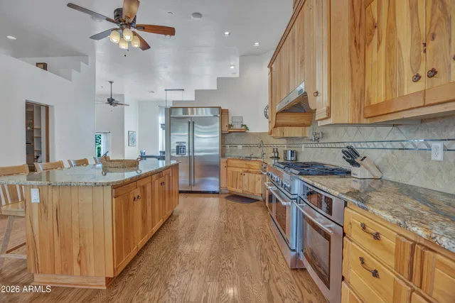 a living room with furniture a dining table and a chandelier