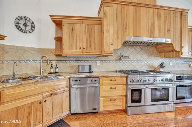 a spacious bathroom with double vanity and a mirror