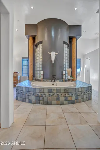 a bedroom with a bed a clock and a chandelier