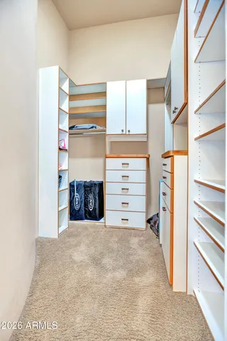 a bedroom with bed and a chandelier