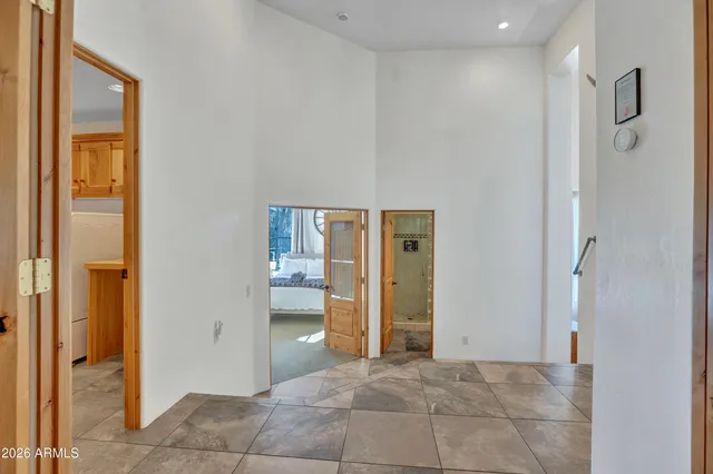 a bedroom with a bed and a lamp on dresser