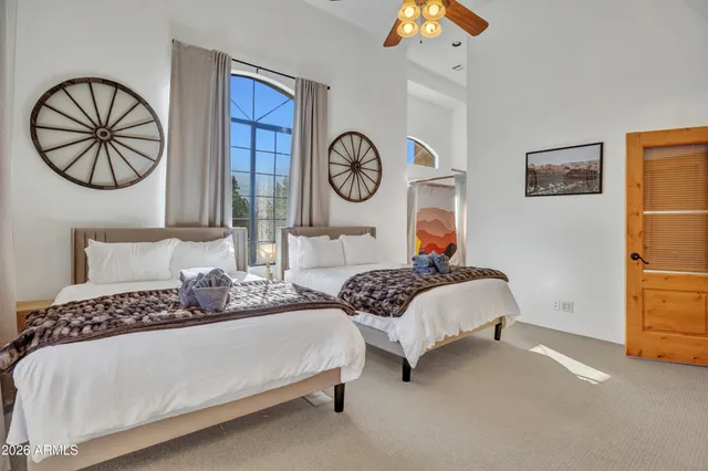 a bedroom with a bed and a view of living room