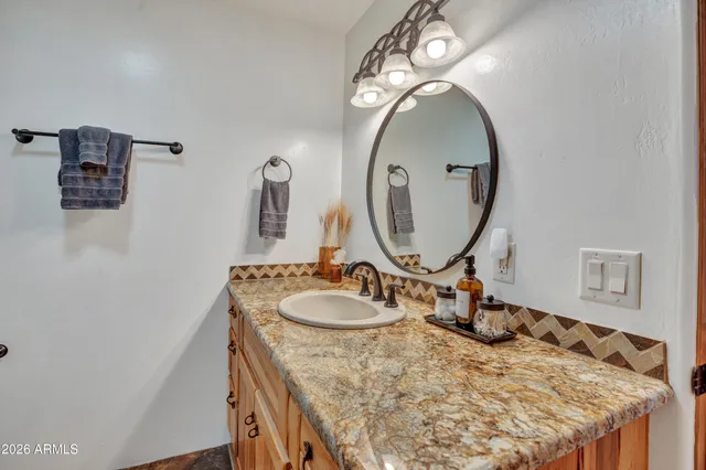 a view of a patio with a table and chairs under an umbrella