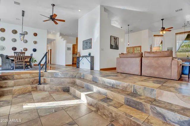 a view of a patio with table and chairs with wooden floor and fence