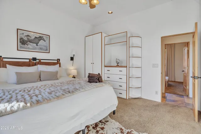 an aerial view of residential houses with outdoor space and trees