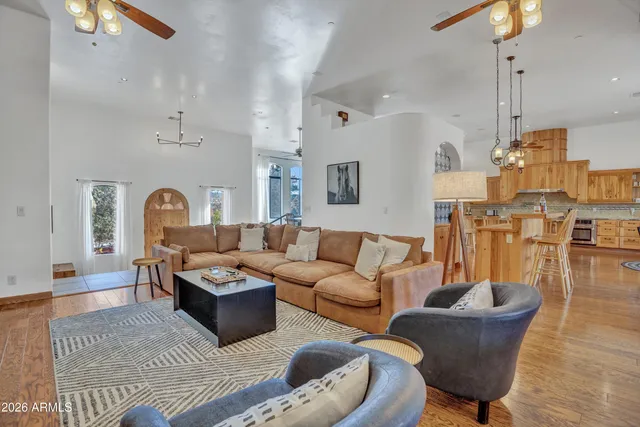 a kitchen with white cabinets and wooden floor