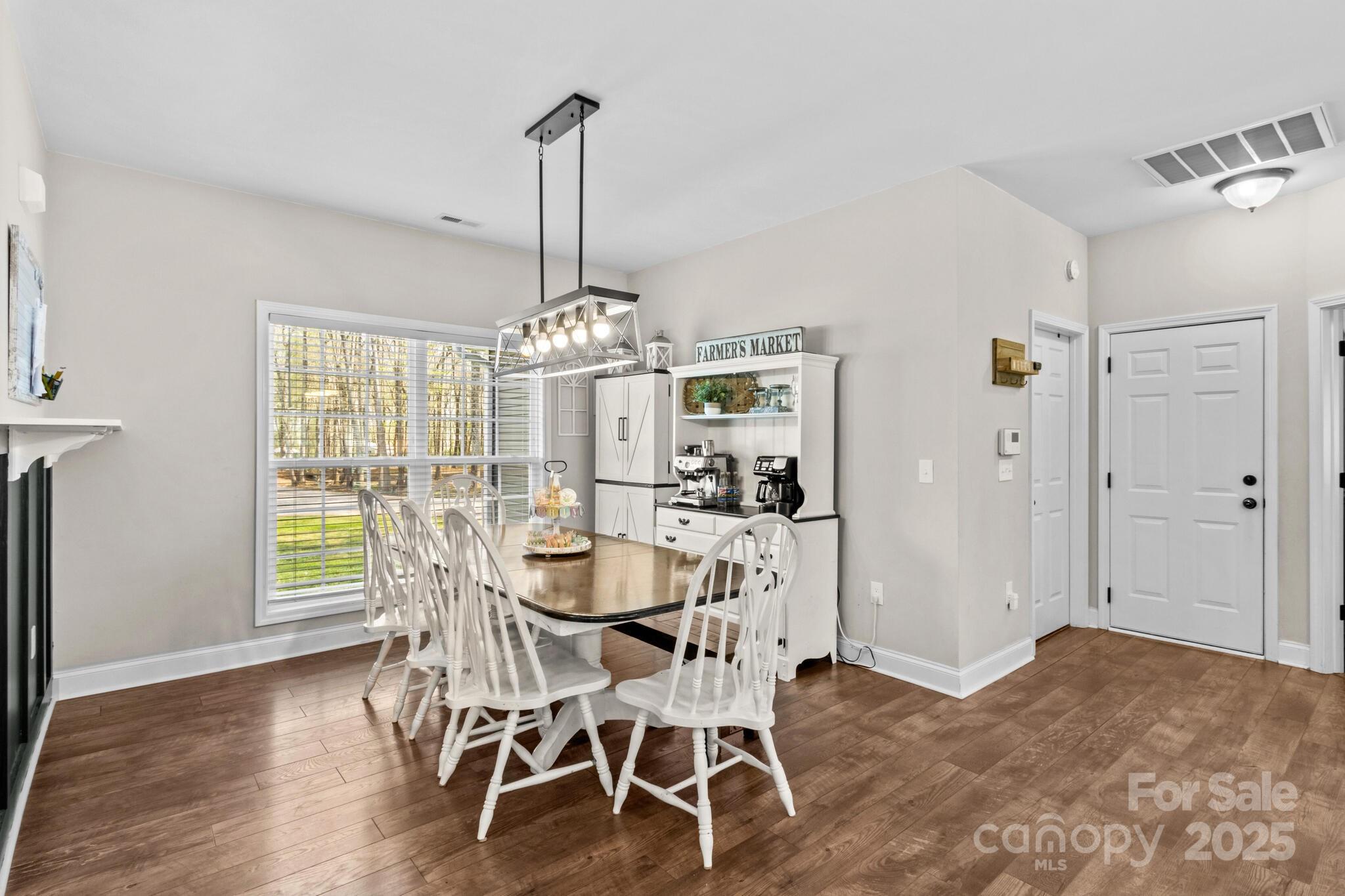 9060 Castor Road Salisbury, NC 28146 - Photo 21 of 47 a view of a dining room with furniture a chandelier and wooden floor