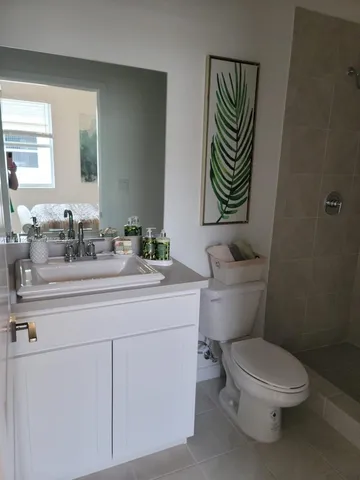 a bathroom with a sink a toilet and a mirror