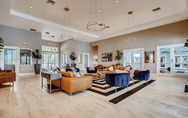 a living room with furniture ceiling fan and a rug