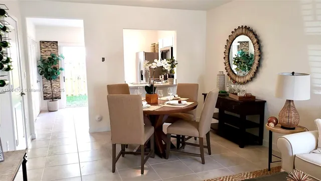 a dining room with furniture and a mirror