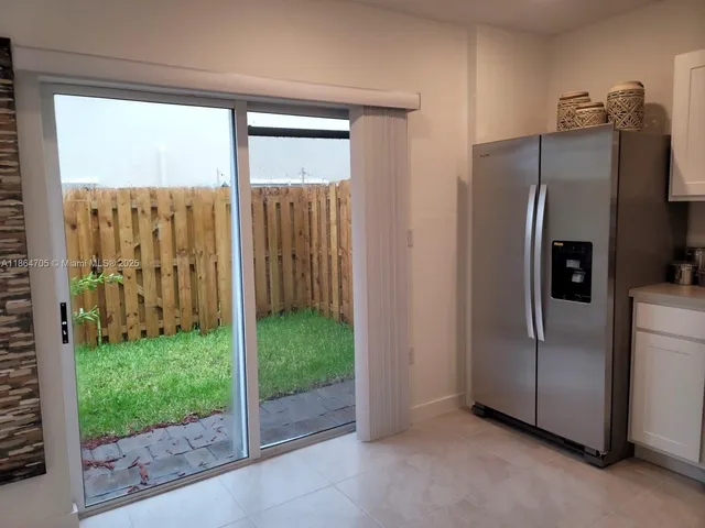 a view of a refrigerator in kitchen and living room