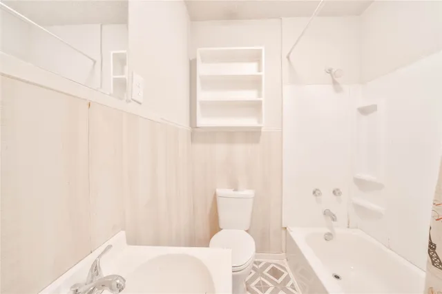 a bathroom with a bathtub and sink