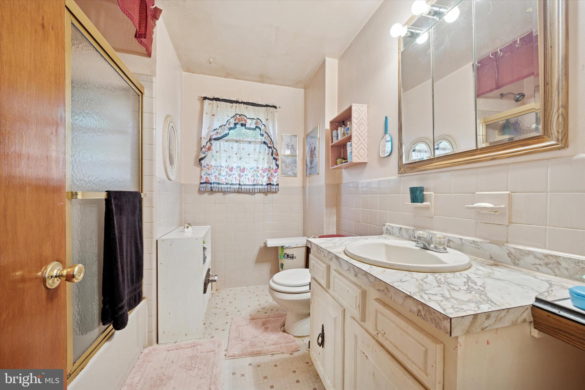 662 South Oak Avenue Secane, PA 19018 - Photo 18 of 39 a bathroom with a granite countertop sink mirror vanity and toilet
