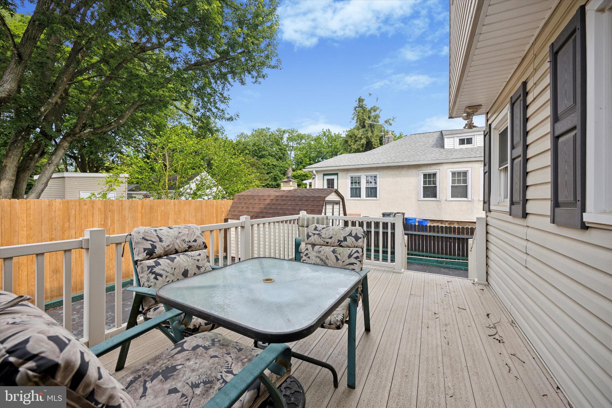 662 South Oak Avenue Secane, PA 19018 - Photo 32 of 39 a view of a roof deck with table and chairs with wooden floor and fence