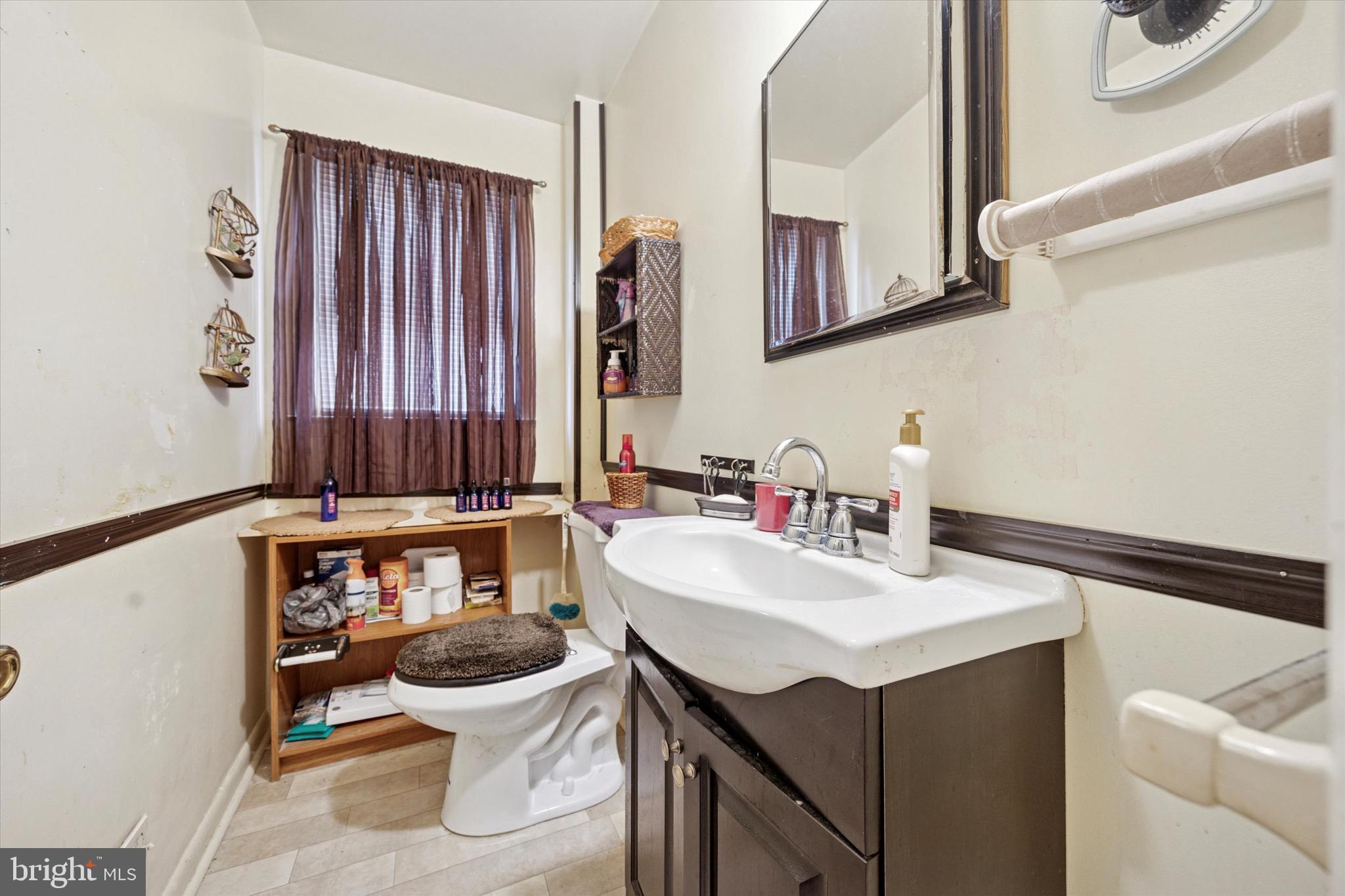 662 South Oak Avenue Secane, PA 19018 - Photo 7 of 39 a bathroom with a sink a toilet and a mirror