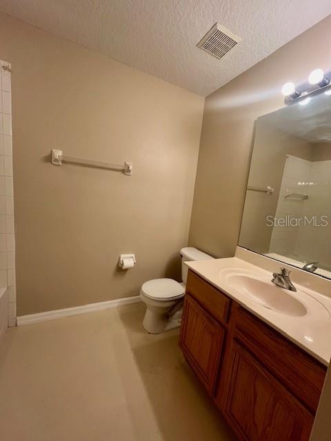 1268 Celebration Avenue Celebration, FL 34747 - Photo 11 of 25 a bathroom with a granite countertop sink a toilet and a mirror
