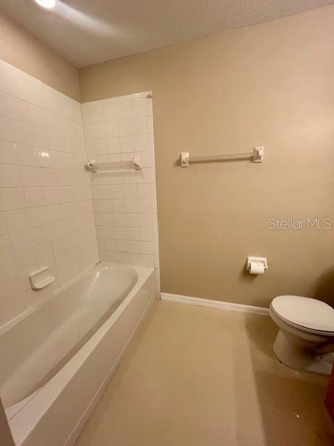 1268 Celebration Avenue Celebration, FL 34747 - Photo 12 of 25 a bathroom with a granite countertop sink a toilet and shower