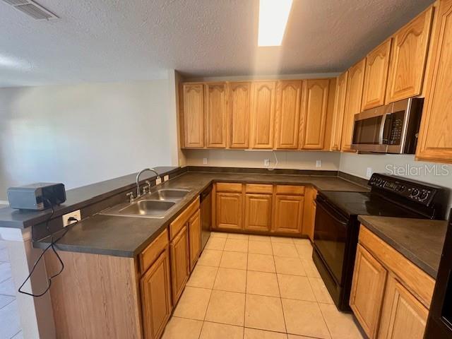 1268 Celebration Avenue Celebration, FL 34747 - Photo 24 of 25 a kitchen with a sink stove and microwave