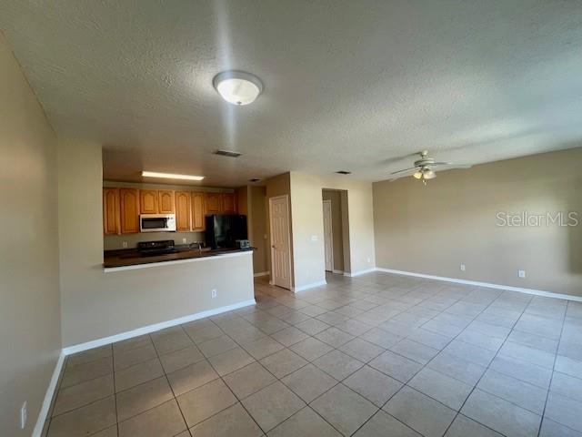 1268 Celebration Avenue Celebration, FL 34747 - Photo 5 of 25 a view of a kitchen with a sink and a refrigerator