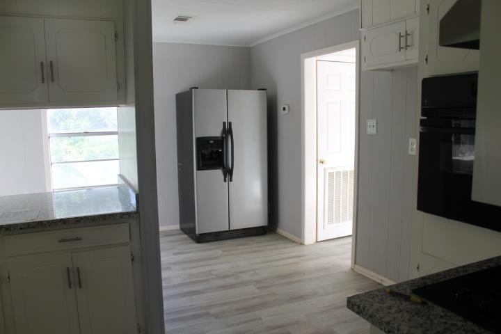 875 Woodrow Street Silsbee, TX 77656 - Photo 18 of 30 a kitchen with stainless steel appliances a refrigerator and a stove top oven
