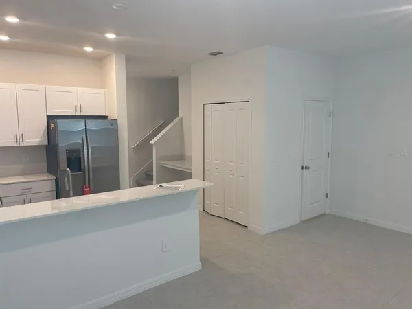 an empty room with a cabinet and mirrors