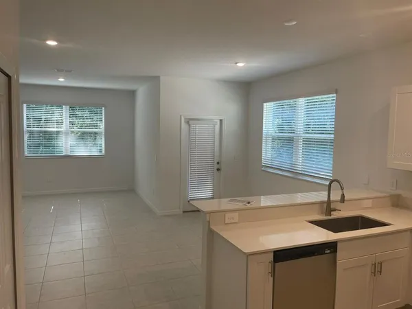 a kitchen with a sink cabinets and window