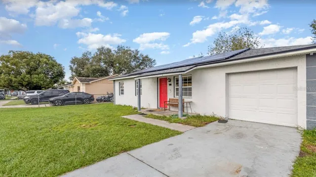 a front view of house with yard and outdoor seating