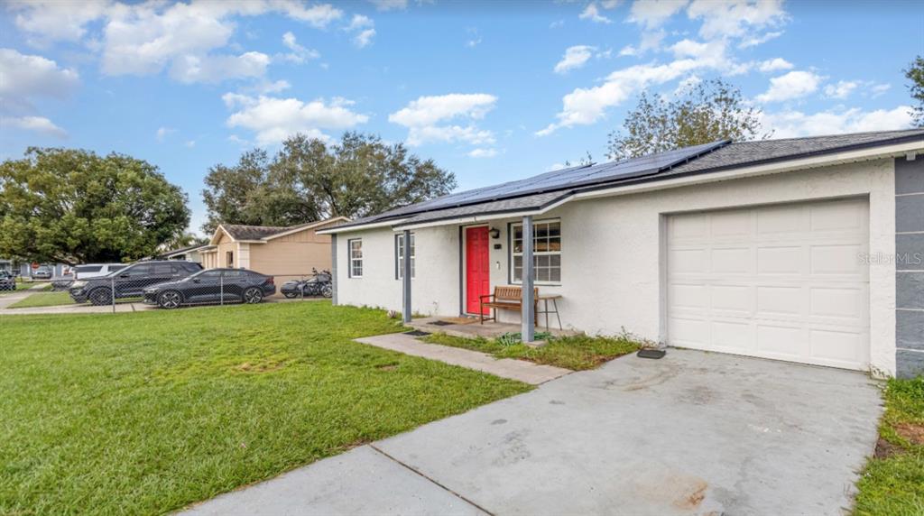 a front view of house with yard and outdoor seating