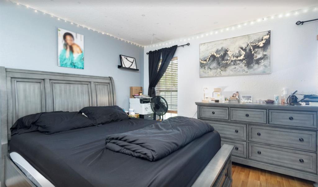 3818 Laso Way Orlando, FL 32822 - Photo 11 of 19 a living room with furniture and wooden floor