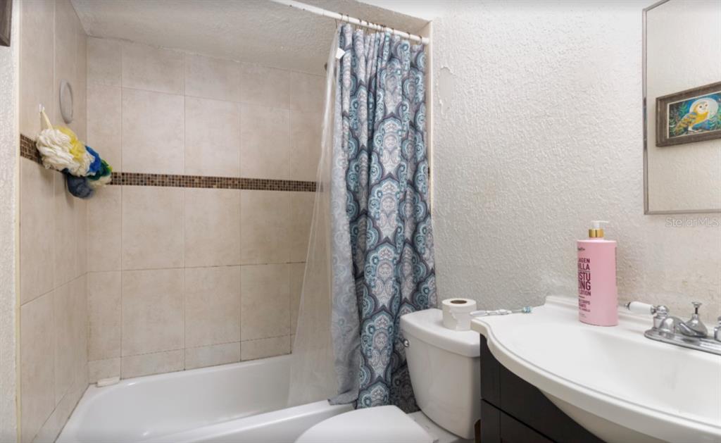 3818 Laso Way Orlando, FL 32822 - Photo 16 of 19 a bathroom with a sink a toilet and shower