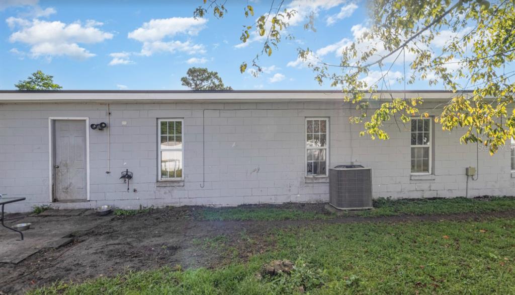 3818 Laso Way Orlando, FL 32822 - Photo 18 of 19 a view of a house with a yard and garage