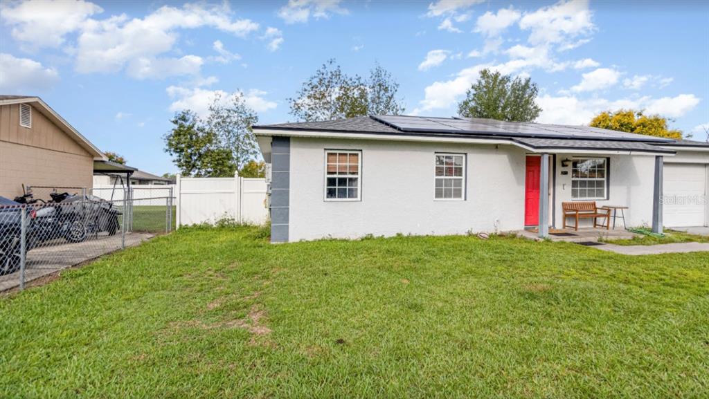 3818 Laso Way Orlando, FL 32822 - Photo 3 of 19 a view of a house with yard and a garden