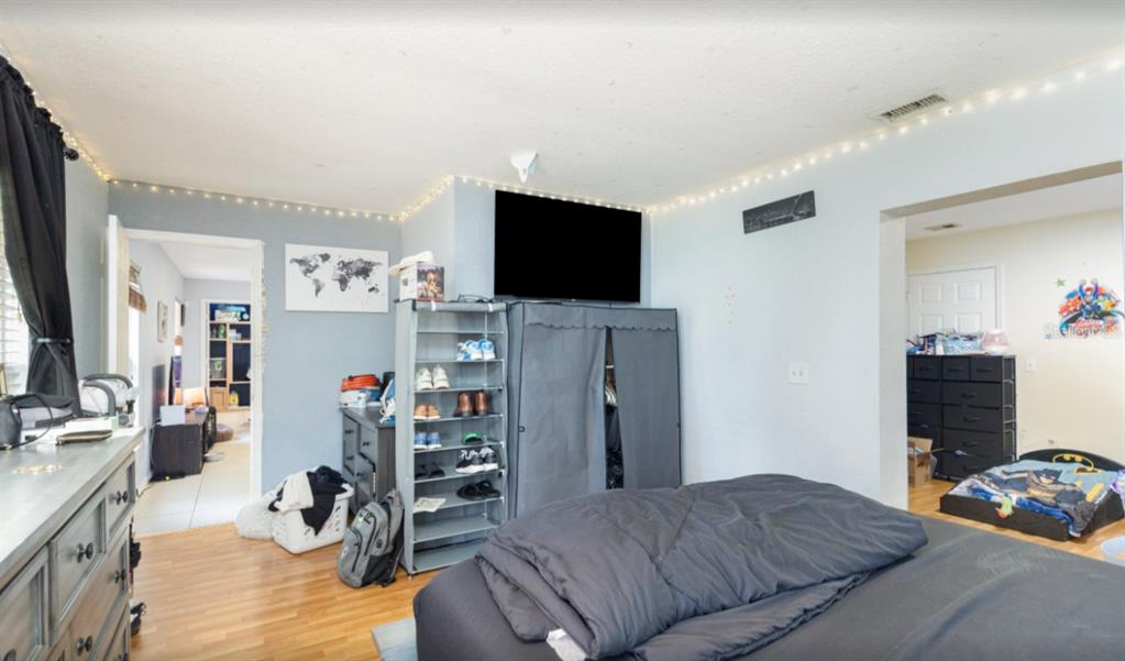 3818 Laso Way Orlando, FL 32822 - Photo 10 of 19 a bedroom with furniture and a flat screen tv