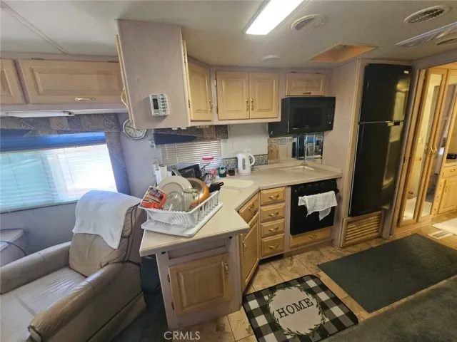 a kitchen with stainless steel appliances a stove a sink and a microwave