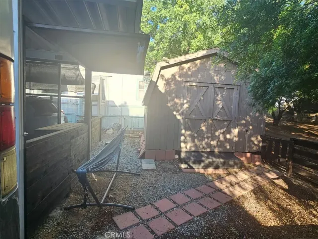 a view of house with swimming pool and a yard