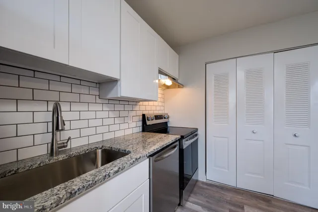 a kitchen with a sink and cabinets