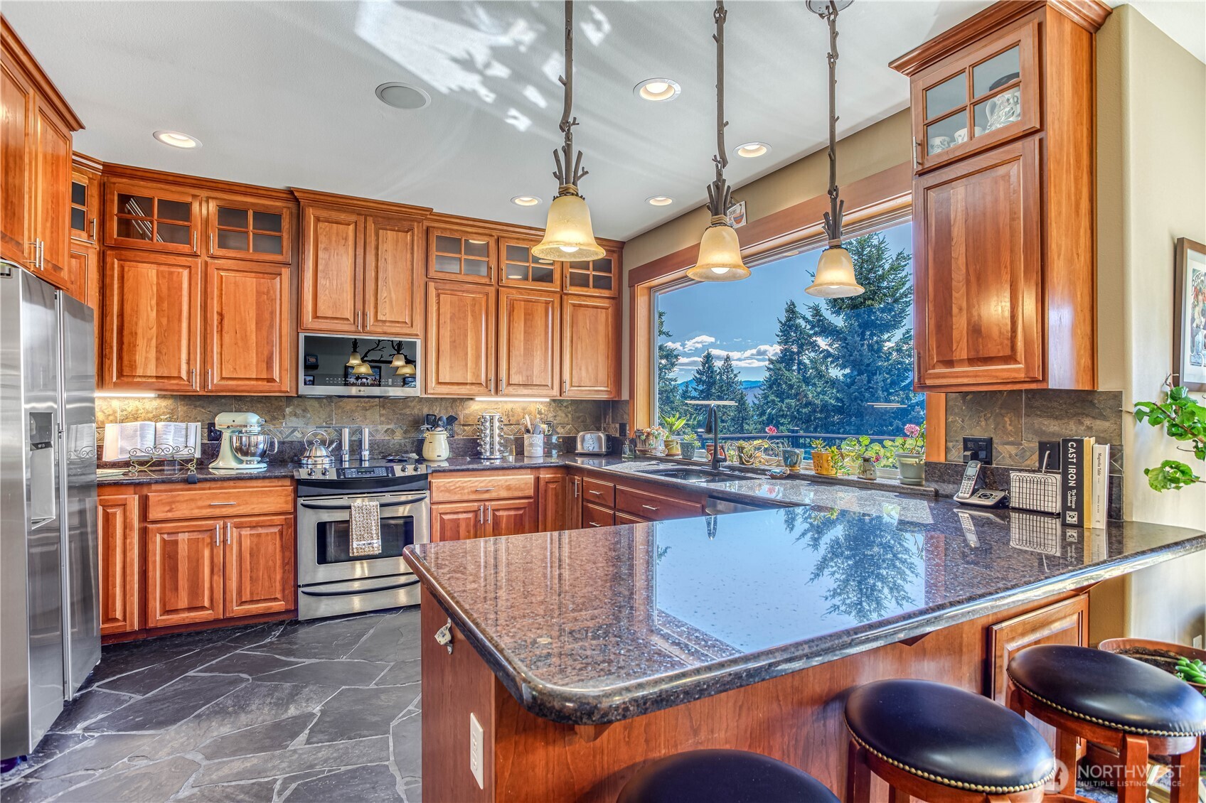 145 Lava Lane Ronald, WA 98940 - Photo 13 of 39 a kitchen with stainless steel appliances granite countertop a sink a stove and a wooden cabinets