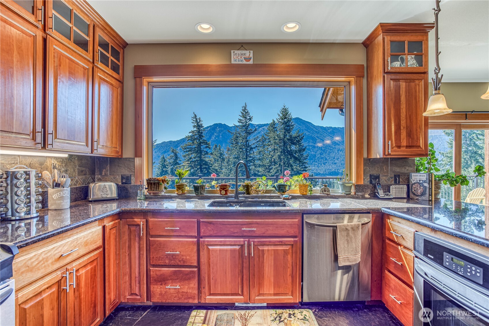 145 Lava Lane Ronald, WA 98940 - Photo 14 of 39 a kitchen with granite countertop a sink and wooden cabinets