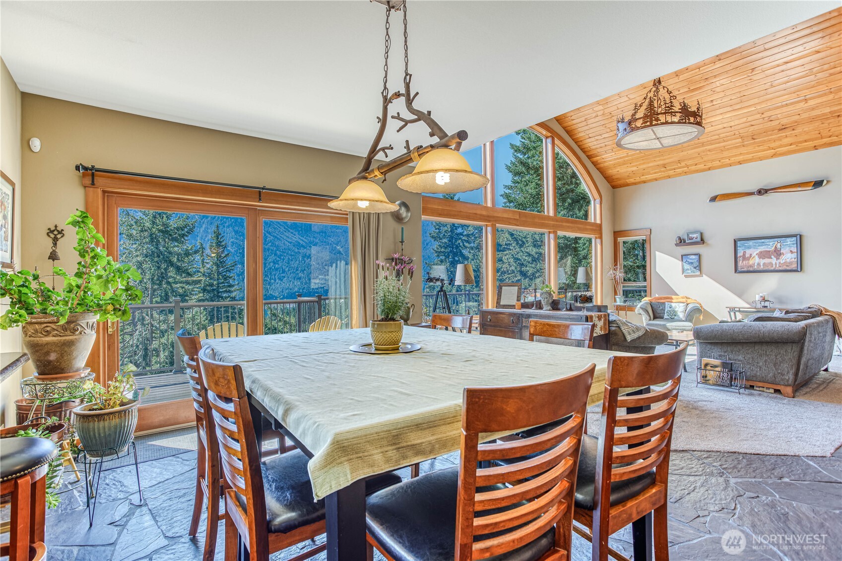 145 Lava Lane Ronald, WA 98940 - Photo 16 of 39 a dining room with furniture large windows and a chandelier