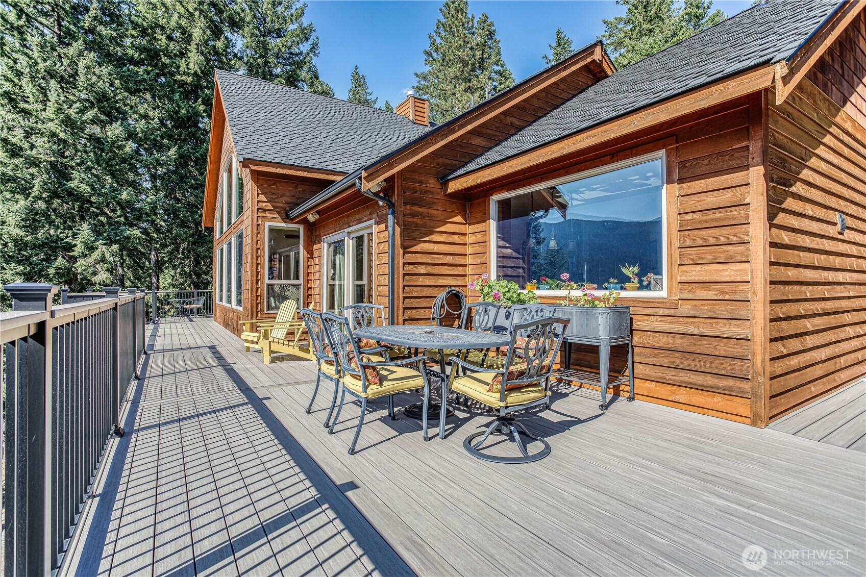 145 Lava Lane Ronald, WA 98940 - Photo 34 of 39 a view of deck with table and chairs wooden floor and fence