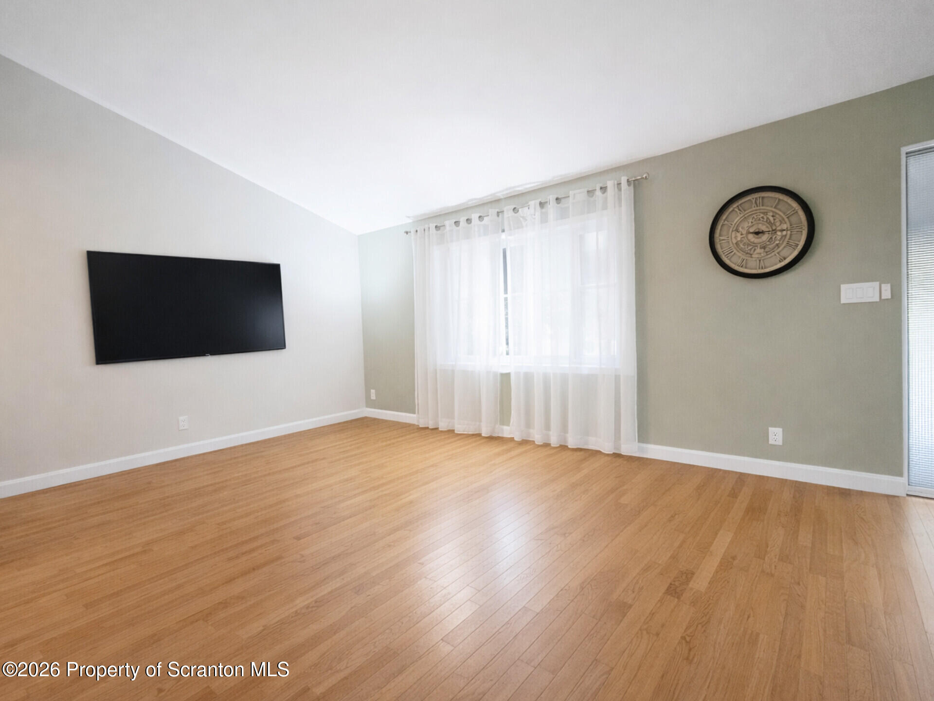 215 Lake Scranton Road Scranton, PA 18505 - Photo 11 of 25 a view of an empty room with wooden floor and a window